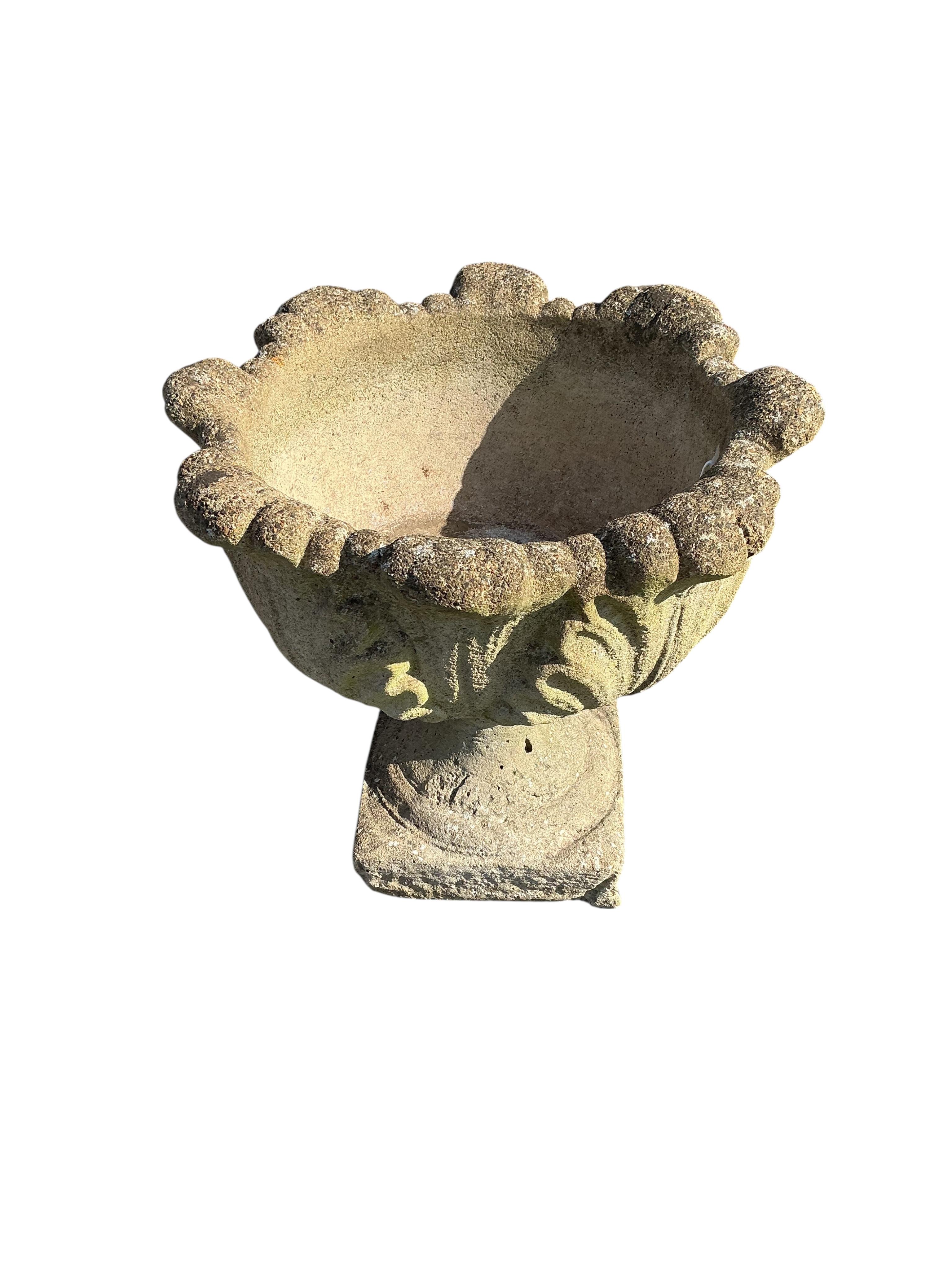 A set of four circular reconstituted stone garden planters, diameter 48cm, height 46cm